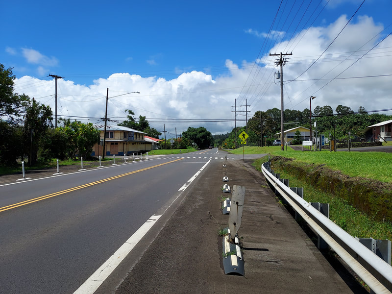 View of Mill Road intersection heading south on Belt Highway 19 from Honoka'a/Hamakua.